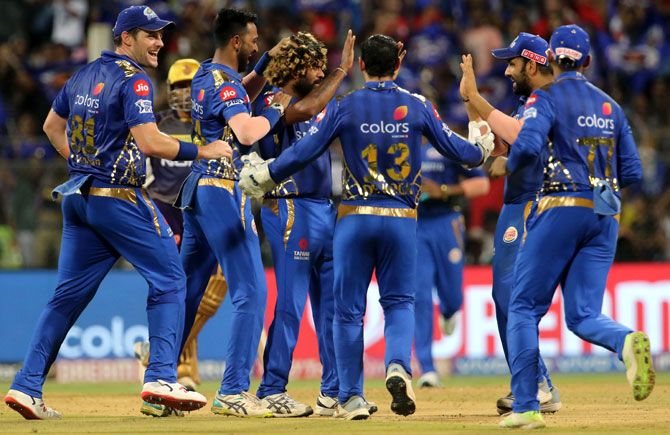Mumbai Indians players celebrate the dismissal of Andre Russell