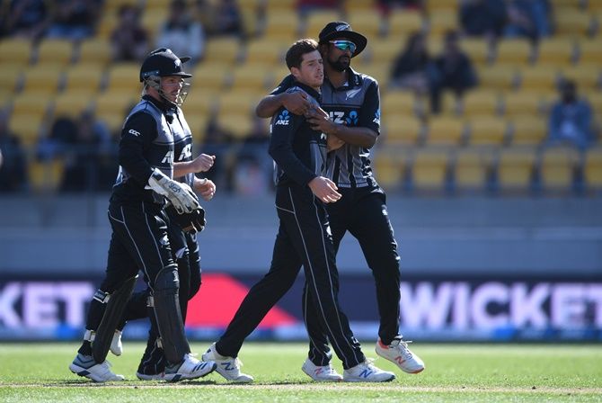 Mitchell Santner celebrates with his New Zealand teammates Ish Sodhi after dismissing Chris Jordan of England during Game 2 of the Twenty20 International series, at Westpac Stadium, in Wellington, on Sunday.