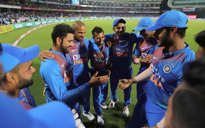 Skipper Rohit Sharma is congratulated by teammates on featuring in 100 T20 Internationals before the start of the second match of the series against Bangladesh in Rajkot on Thursday. 