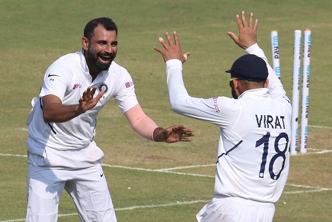 India pacer Mohammed Shami celebrates with skipper Virat Kohli after dismissing Bangladesh batsman Mushfiqur Rahim