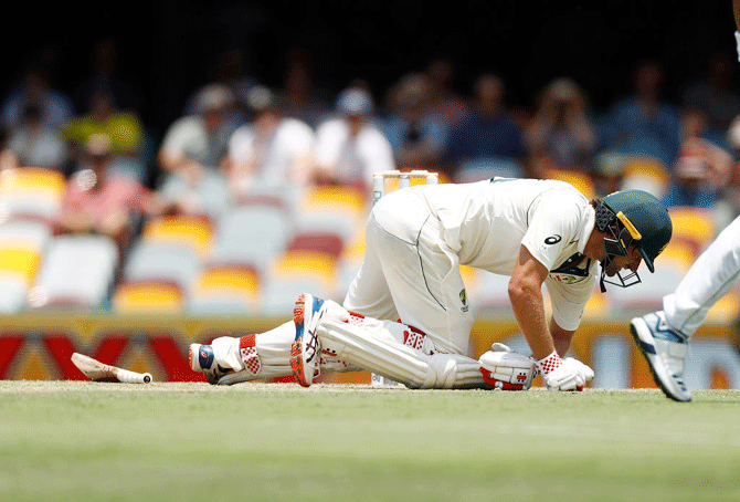 Australia's Joe Burns goes to ground after being struck by a delivery off Pakistan's Naseem Shah