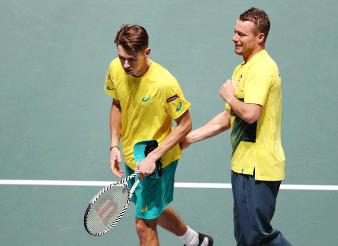 Australia's Alex de Minaur celebrates with captain Lleyton Hewitt after winning his match against Canada's Denis Shapovalov