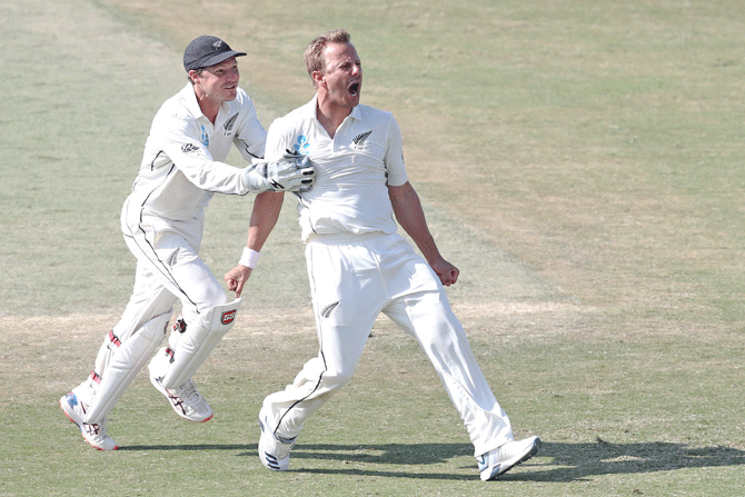 New Zealand's Neil Wagner (right) celebrates with BJ Watling (left) after taking the wicket of England's Stuart Broad to win the first Test match on day five at Bay Oval in Mount Maunganui, New Zealand on Monday