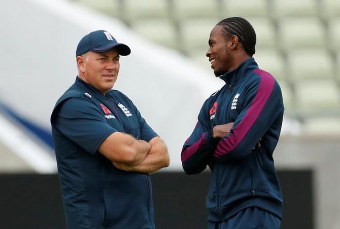 England's pacer Jofra Archer chalts bowling coach Chris Silverwood during nets.