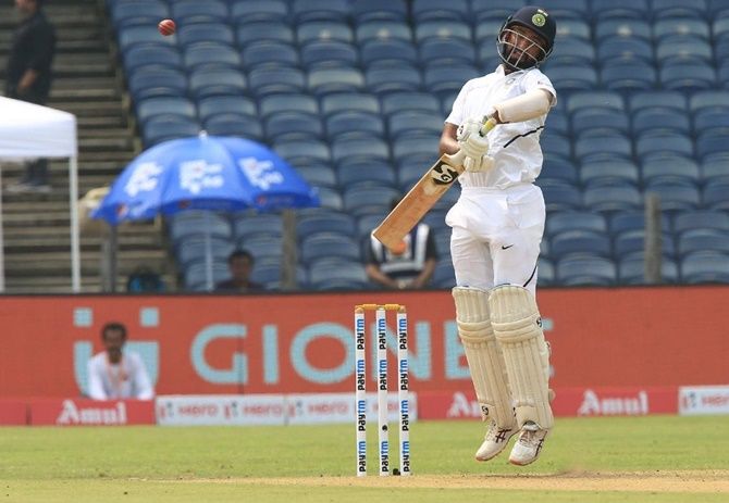 Cheteshwar Pujara checks his shot to avoid a bouncer from Anrich Nortje