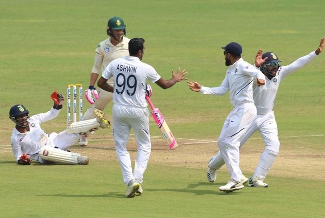 Ravichandran Ashwn celebrates with teammates after Wriddhiman Saha catches Faf du Plessis