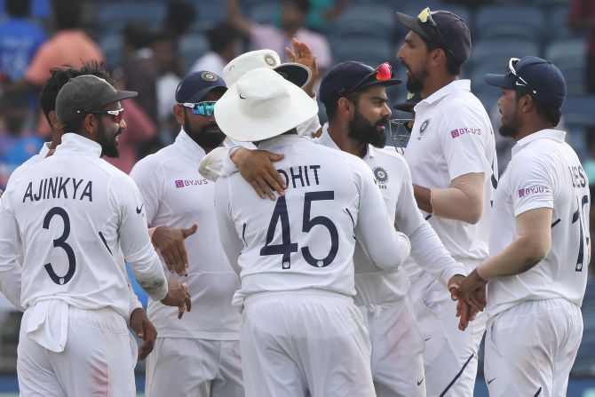 Indian players celebrate the wicket of Keshav Maharaj to win the second Test in Pune on Sunday 