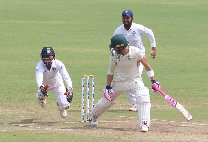 Wicketkeeper Wriddhiman Saha takes a brilliant catch to dismiss Faf du Plessis off Ravichandran Ashwin's bowling.