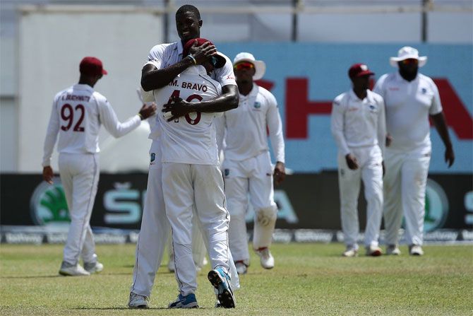 West Indies captain Jason Holder celebrates after taking the wicket of Cheteshwar Pujara