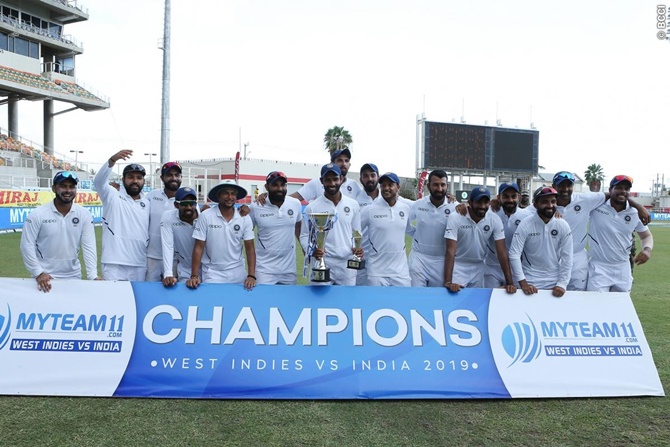 India’s players pose for a picture following the presentation ceremony after winning the second Test and series against the West Indies 