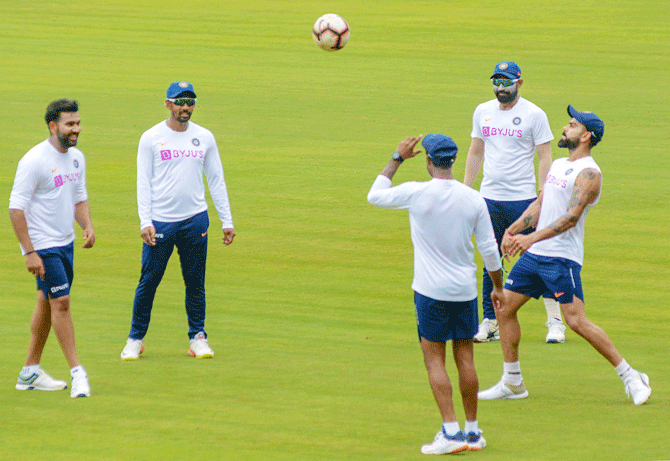 The Indian cricket team warm-up with some football