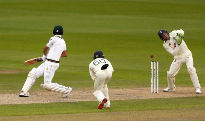 England's Jos Buttler misses the stumping of Pakistan's Shan Masood