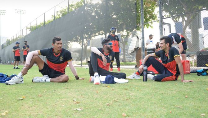 RCB's Navdeep Saini, Mohammed Siraj and Yuzvendra Chahal rest during the training session on Saturday.