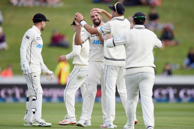 New Zealand's Daryl Mitchell is congratulated by team mates after dismissing West Indies' Jason Holder on Day 3 of the 1st Test at Seddon Park in Hamilton on Saturday