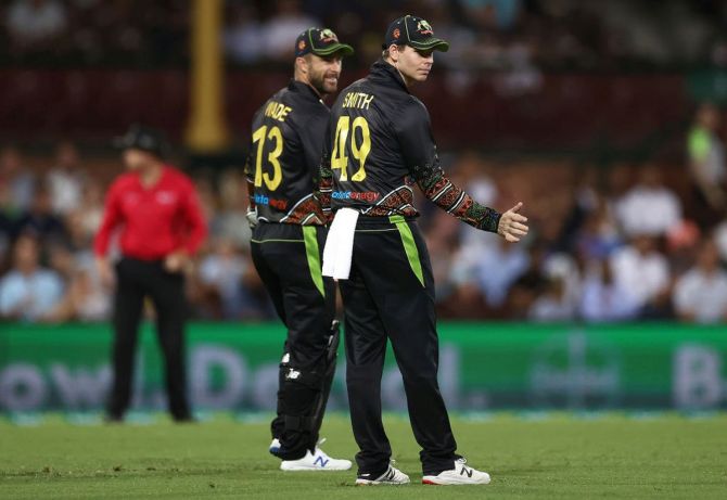 Matthew Wade speaks to Steve Smith during the 3rd T20I against India at Sydney on Sunday. Coach Justin Langer said Smith was among "a number" considered before selectors opted for Wade. 