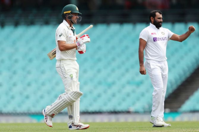 Australia A's Joe Burns walks back after being dismissed by India's Mohammed Shami