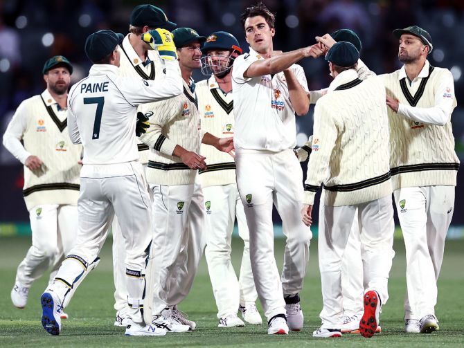 Australia's players celebrate the wicket of opener Prithvi Shaw in India's second innings, on Day 2.