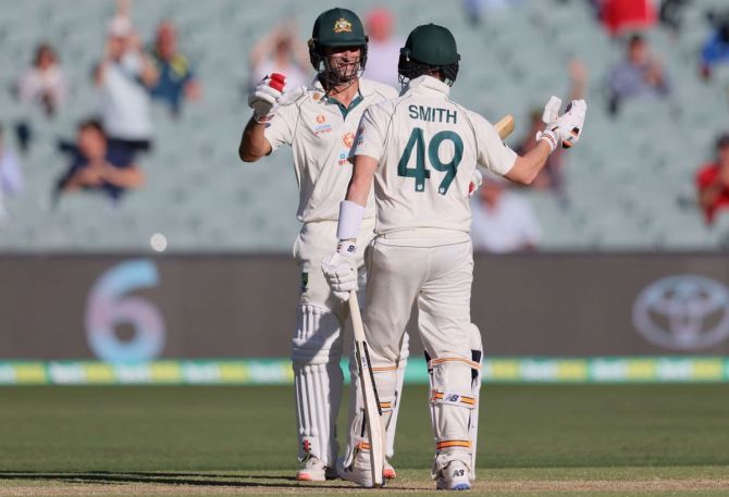 Australia's Joe Burns is congratulated by Steve Smith after he hit a six to get to his 50 and score the winning runs. 