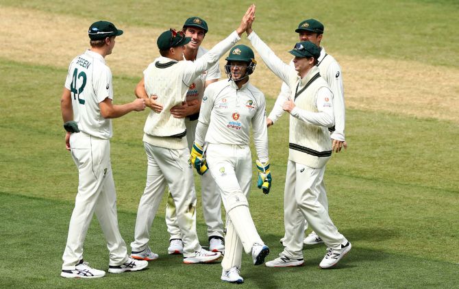 Australia's players celebrate India captain Ajinkya Rahane's dismissal
