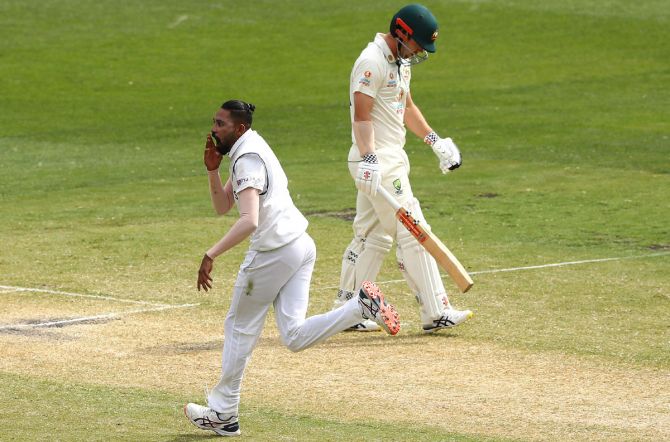 Mohammed Siraj celebrates taking the wicket of Travis Head