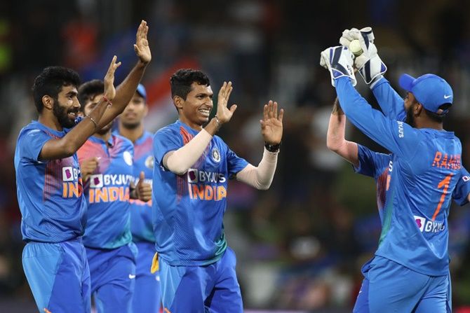 India's Navdeep Saini, centre, celebrates after taking the wicket of New Zealand's Ross Taylor during Game 5 of the Twenty20 series, at Bay Oval, in Mount Maunganui, on Sunday.