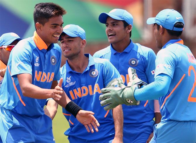 Kartik Tyagi is congratulated by his India teammates after claiming a wicket.