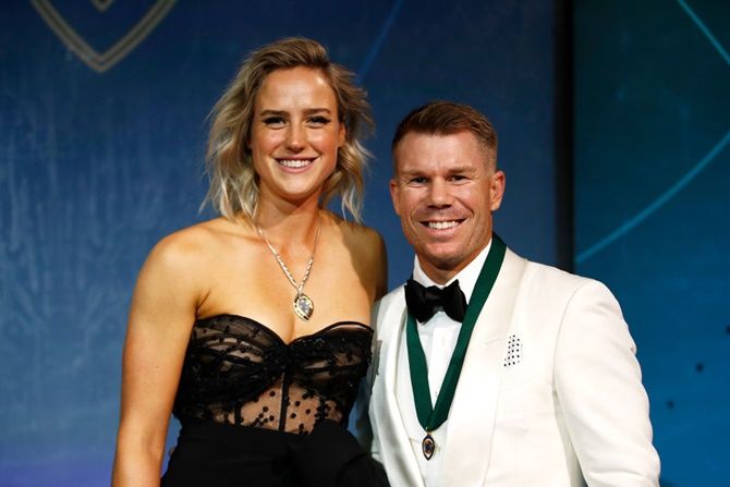 Ellyse Perry (left), winner of the Belinda Clark Award, and David Warner, winner of the Allan Border Medal, show off their medals  during the 2020 Cricket Australia Awards