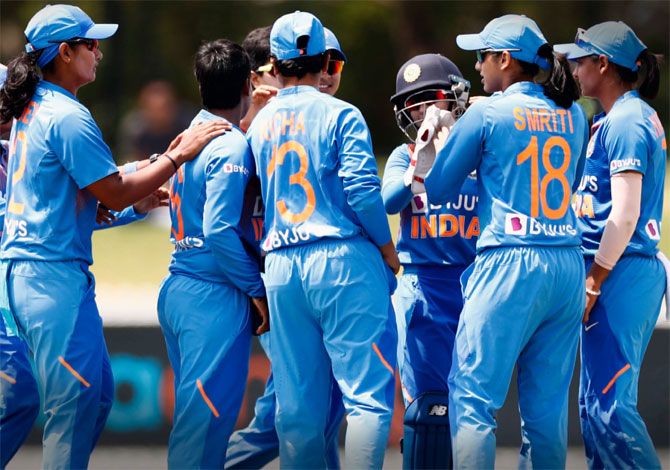 India's players celebrate the fall of a West Indies wicket