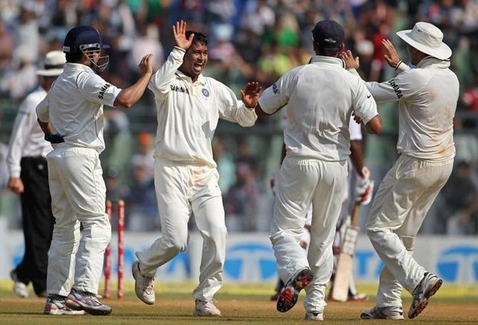 Pragyan Ojha celebrates after taking a wicket