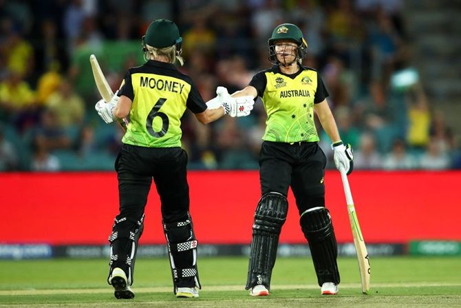 Australia's openers Alyssa Healy and Beth Mooney celebrate their 100-run partnership during the ICC Women's T20 World Cup match against Bangaldesh
