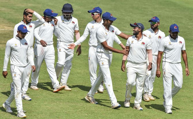 Mumbai left-arm spinner Shams Mulani, centre, who claimed 4 for 72 and scored 87, is congratulated by teammates at the end of the Ranji Trophy match against Tamil Nadu at the MAC stadium, in Chennai, on Tuesday