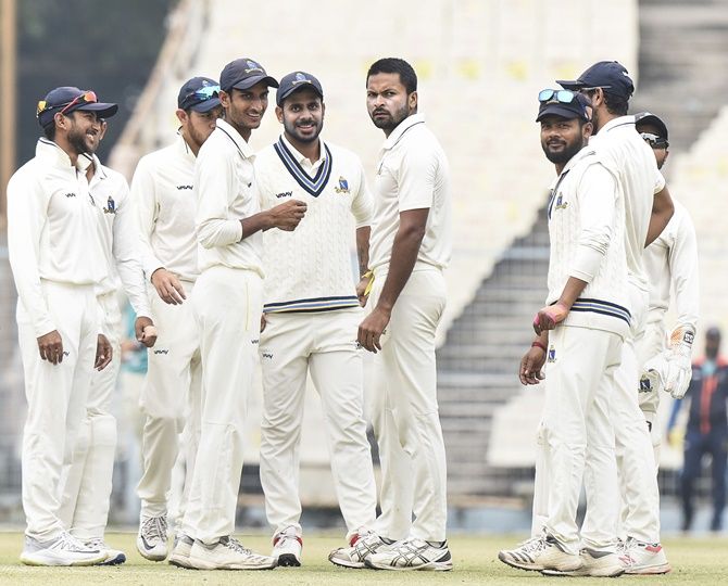 Bengal pacer Mukesh Kumar celebrates with teammates after dismissing Delhi's Anuj Rawat on Day 3 of their Ranji Trophy match at the Eden Gardens, in Kolkata
