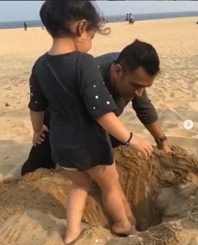 Mahi plays with his daughter on a beach