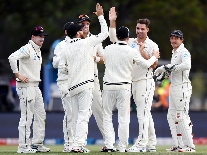New Zealand players celebrate the dismissal of India captain Virat Kohli in the second innings on Day 2 of the second Test, at Hagley Oval in Christchurch, on Sunday.
