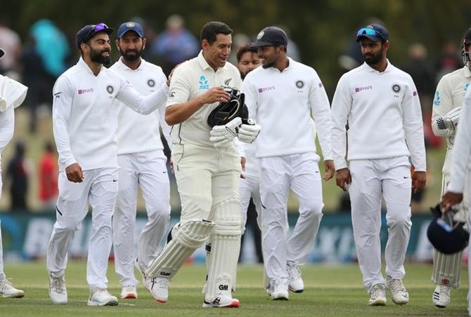Captain Virat Kohli and his India teammates congratulate New Zealand's Ross Taylor as they leave the field at the end of the second Test, on Day 3, at Hagley Oval in Christchurch, on Monday.