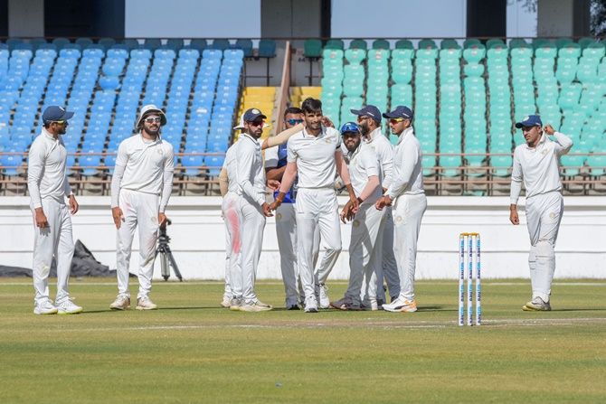 Saurashtra's Chirag Jani is congratulated by teammates after dismissing Bengal batsman Manoj Tiwary during Day 3 of the Ranji Trophy final, in Rajkot, on Wednesday.