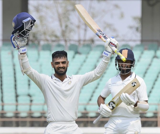 Saurashtra’s Cheteshwar Pujara applauds as Arpit Vasavada celebrates completing a hundred on Day 2 of the Ranji Trophy final against Bengal in Rajkot. 