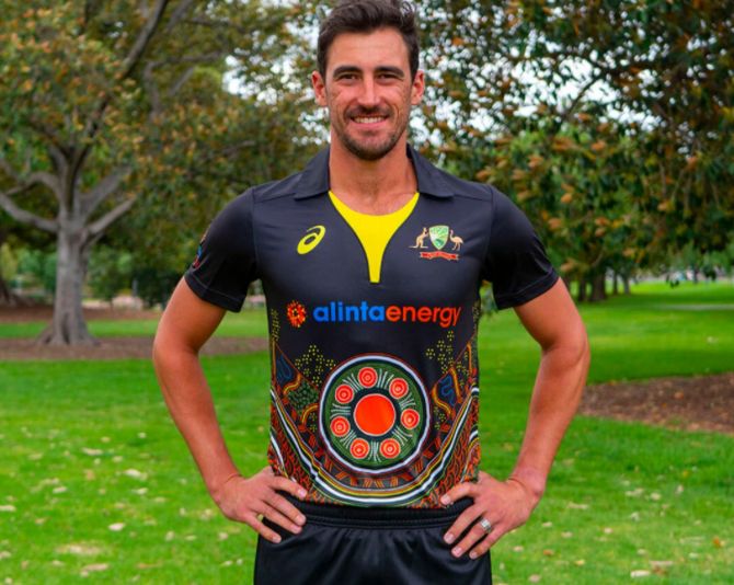 Australia pacer Mitchell Starc models the new jersey that will be worn during the T20Is against India
