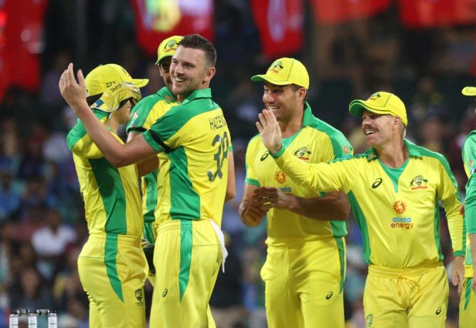 Australia's Josh Hazlewood and Alex Carey celebrate with Marcus Stoinis and David Warner after taking the wicket of India's Shreyas Iyer