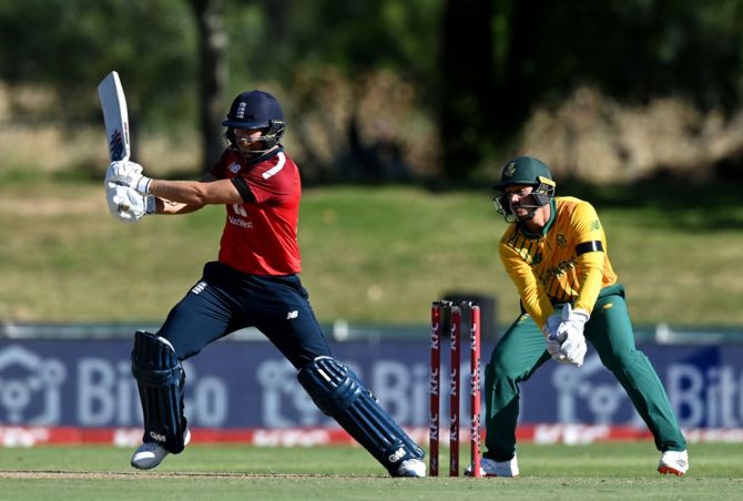 England's Dawid Malan  plays a shot as South Africa's wicketkeeper Quinton de Kock looks on during the second T20 International at Boland Park in Paarl, South Africa, on Sunday. 