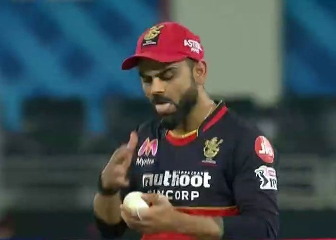Screenshot of Virat Kohli applying saliva to the ball.
