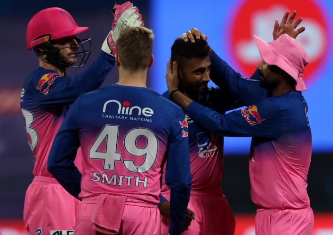 Rajasthan Royals players celebrate the dismissal of Rohit Sharma.