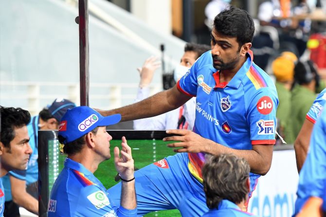 Delhi Capitals spinner Ravichandran Ashwin and coach Ricky Ponting have a word in the dugout during their Indian Premier League against Royal Challengers Bangalore, in Dubai.