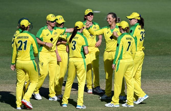 Australia's Sophie Molineux celebrates with teammates after taking the wicket of New Zealand's Hayley Jenson during game three of the Women's One Day International series at Allan Border Field in Brisbane on Wednesday