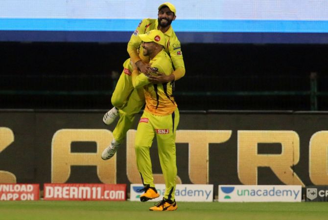 Ravindra Jadeja and Faf du Plessis celebrate after they combined to take the relay catch to dismiss Sunil Narine off Karn Sharma's bowling