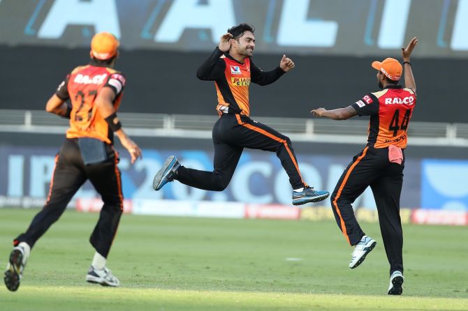 Rashid Khan celebrates the wicket of Sanju Samson.