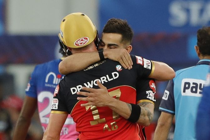 Royal Challengers Bangalore skipper Virat Kohli embraces AB de Villiers after his match-winning knock in the IPL game against Rajasthan Royals, in Dubai, on Saturday