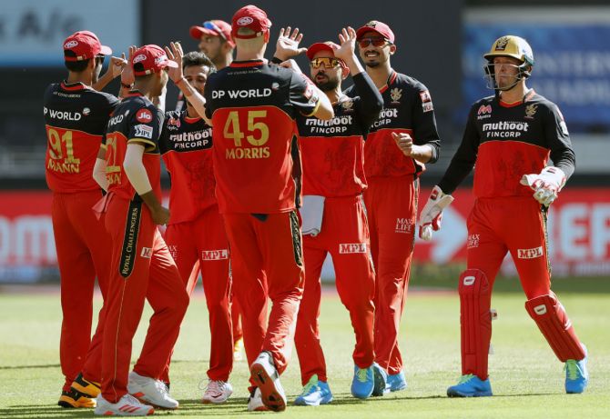 Royal Challengers Bangalore's players celebrate after Yuzvendra Chahal gets the wicket of Sanju Samson