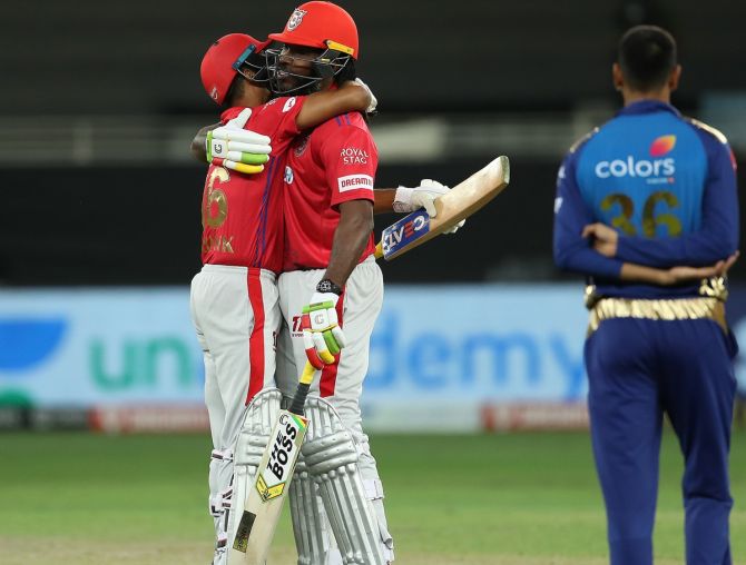 Chris Gayle and Mayank Agarwal embrace after Kings XI clinch victory over MUmbai Indians via the second Super over in Sunday's IPL match in Dubai