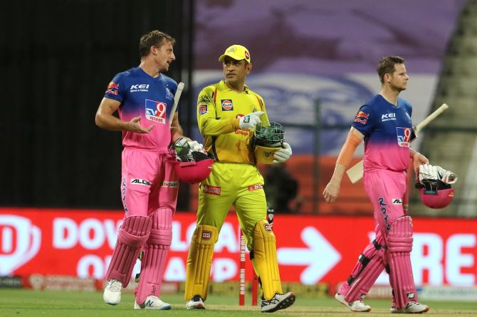 Rajasthan Royals batsmen Jos Buttler and Steven Smith walk back with Chennai Super Kings skipper Mahendra Dhoni after clinching victory in the IPL match in Abu Dhabi on Monday.